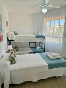 a bedroom with two bunk beds and a window at Apartamento Deluxe1ºA in Benidorm +51 photos