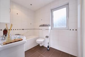 a white bathroom with a toilet and a sink at The Art Gallery - Jacqueline's Place - By T&S in Eindhoven