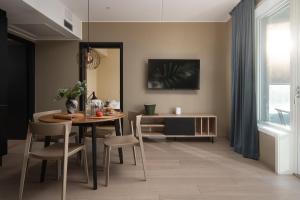 a dining room with a table and chairs and a window at BJØRVIKA APARTMENTS, Opera Area, Oslo city center in Oslo