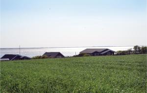 a field of green grass with houses in the background at Apartment Esbjerg V With Patio Vi in Sjælborg