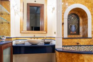 a bathroom with a sink and a mirror at Casa Rajada Sorrento in Sorrento