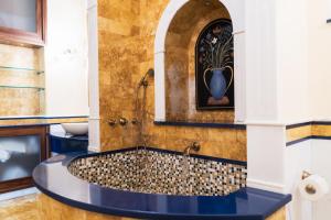 a bathroom with a large tub with a sink at Casa Rajada Sorrento in Sorrento