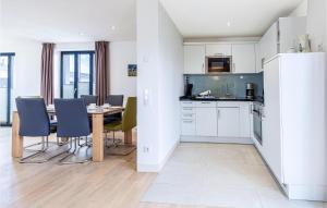 a kitchen and dining room with a table and chairs at Penthouse Garden in Binz