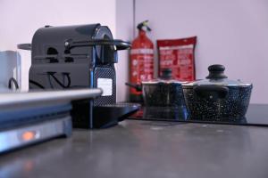 a counter top with a coffee maker on it at The Art Gallery - Mario's Place - By T&S in Eindhoven