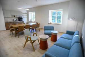 a living room with a blue couch and a table at Pensjonat Sztynort in Sztynort +69 photos