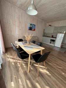a dining room table and chairs in a room at Sodyba Po klevu in Molėtai +26 photos