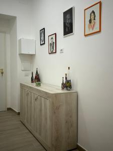 a kitchen with a wooden counter with bottles on it at Gold House in Naples +22 photos