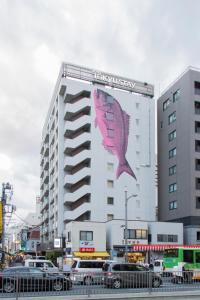 a building with a pink fish on the side of it at Tokyu Stay Tsukiji - Tokyo Ginza Area in Tokyo