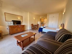 a living room with a couch and a bed at Kingfisher Apartments Benal Beach in Benalmádena