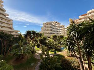 a view of a resort with palm trees and buildings at Kingfisher Apartments Benal Beach in Benalmádena