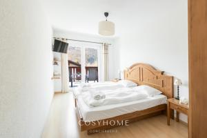A bed or beds in a room at Chalet des Alpes - Sunset View - Crans-Montana