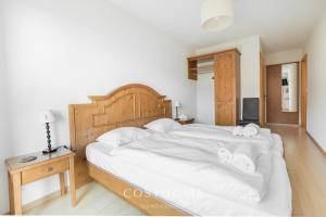A bed or beds in a room at Chalet des Alpes - Sunset View - Crans-Montana