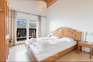 A bed or beds in a room at Chalet des Alpes - Sunset View - Crans-Montana
