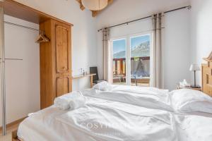 A bed or beds in a room at Chalet des Alpes - Sunset View - Crans-Montana