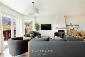 A television and/or entertainment centre at Chalet des Alpes - Sunset View - Crans-Montana