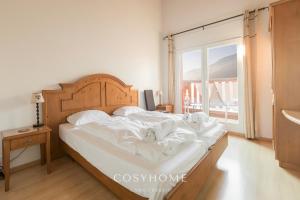 A bed or beds in a room at Chalet des Alpes - Sunset View - Crans-Montana