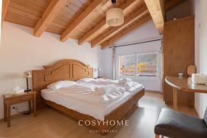 A bed or beds in a room at Chalet des Alpes - Sunset View - Crans-Montana
