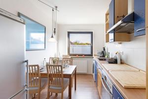 a kitchen with a table and a dining room at Ferienwohnung Obrighoven in Wesel