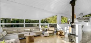 a living room with a couch and a table at Fjordferie Hemmet Strand in Hemmet