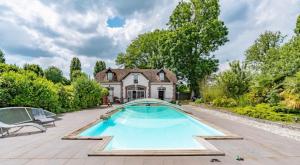 a swimming pool in front of a house at GÎTE VIGNERAIE in Sainte-Gemme-Moronval