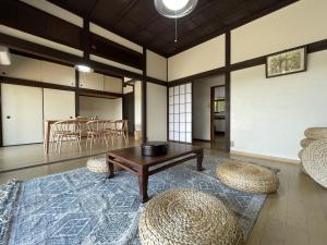 a living room with a table and some chairs at 【 円 madoka 】逗子鎌倉で暮らすように過ごす一棟貸し宿泊施設​ in Zushi