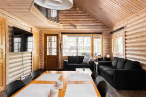 a living room with a table and chairs at Yyteri Beach Lomakeskus, Havulinna 28 in Pori