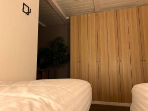 a bedroom with a bed and a wooden cabinet at Appartement 412 Kunners Oostenrijk in Mittelberg