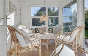 a dining room with a white table and chairs at Holiday Home Kalleholled Gudhjem Denm in Gudhjem