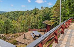 a wooden deck with a picnic table and a gazebo at Amazing Home In Mandal With Wifi in Mandal
