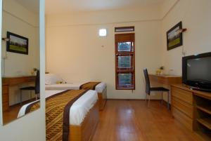 Μια τηλεόραση ή/και κέντρο ψυχαγωγίας στο Rumah Tawa Hotel Syariah