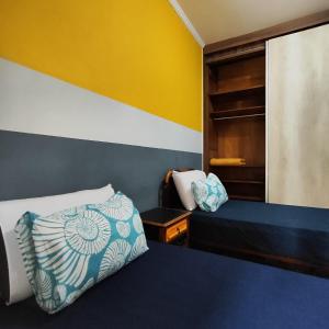 Ένα ή περισσότερα κρεβάτια σε δωμάτιο στο Casa de Praia Muito Aconchegante