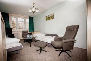 a room with a bed and two chairs and a table at Apartament 3 SYPIALNIE, 3 BEDROOMS - Klimatyzacja - in Wrocław