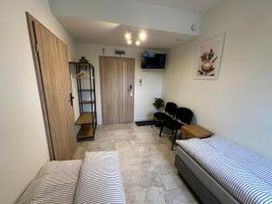 a bedroom with a bed and a room with a door at PrzyStań S7 in Smroków +46 photos