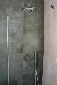 a shower with a glass door and a shower head at Nido Madreperla in Taranto