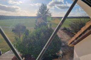 a view of a field from a window at Duplex à la campagne in Velaine-en-Haye