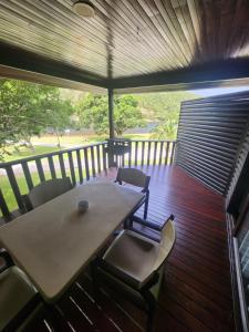 a wooden deck with a table and chairs on it at Plettenberg, a Forever Resort in Plettenberg Bay +23 photos