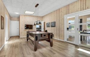 a ping pong table in a room with wooden walls at 6 Bedroom Stunning Home In Glesborg in Glesborg