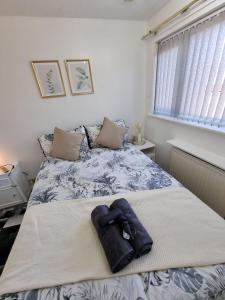 a bedroom with a bed with a robe on it at Modern 2-Bed Home - Private Garden Parking & WiFi in Leeds