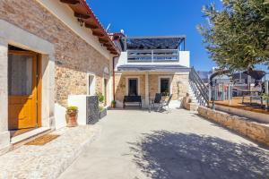 a home with a patio and stairs to a house at Thrapsano House with Private Pool for Families by Hospi Living in Heraklion