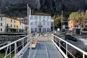 a dock in a town with a white building at Gio House - Affitti Brevi Italia in Onno