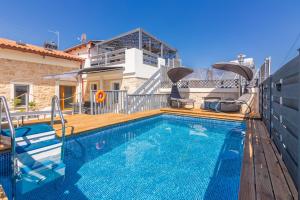 a swimming pool in front of a house at Thrapsano House with Private Pool for Families by Hospi Living in Heraklion