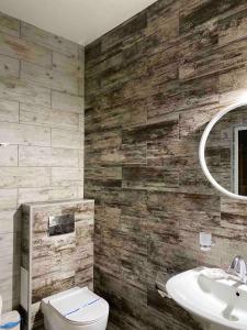 a bathroom with a toilet and a sink at Fontush Boutique Hotel in Ivano-Frankivsʼk