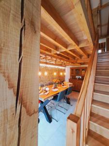 a dining room with a long table and a staircase at Sous la Charpente in La-Roche-en-Ardenne +37 photos