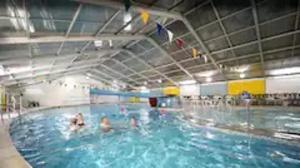 a group of people in a swimming pool at Rebels Retreat - 2-Bed Chalet nr St Ives & Hayle in St Ives