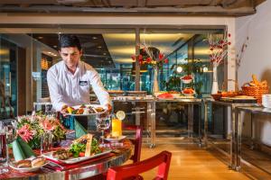 a chef preparing food in a restaurant at Fraser Place Antasya Istanbul in Istanbul