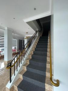 a staircase in a building with black and gold railings at B Hotels Angeles City in Angeles