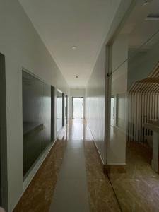 an empty hallway with glass walls and a staircase at B Hotels Angeles City in Angeles