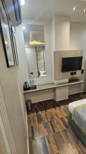 A television and/or entertainment centre at Dashrath Inn near Ramjanmbhoomi