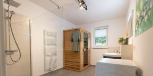 a bathroom with a shower and a toilet and a sink at Residences Central Winterberg in Winterberg
