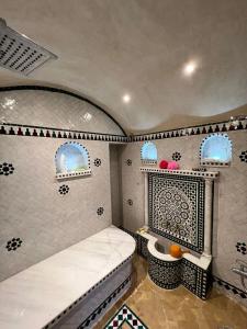 a small room with a bed and a fireplace at Apartment Nazaha for families only in Tangier